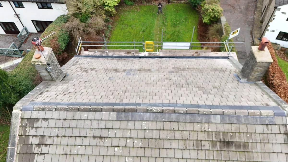 Aerial drone view of a Cumbrian property with a weathered stone roof section viewed from above