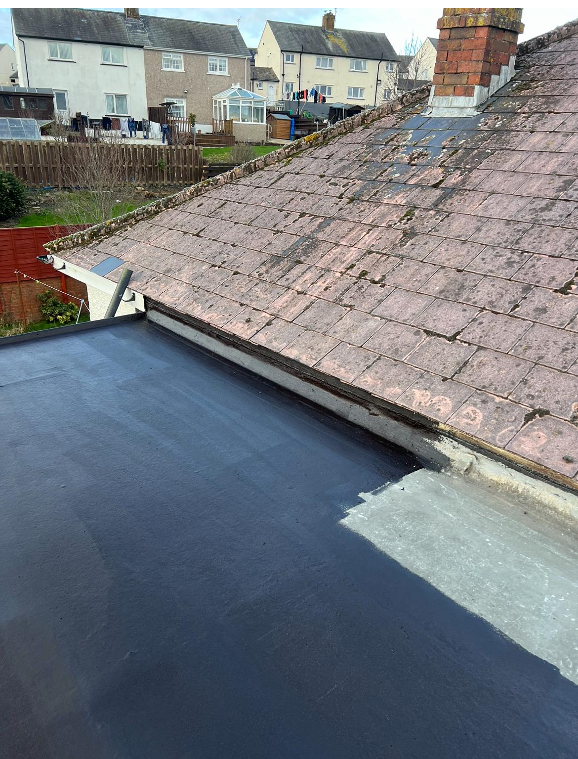 Existing EPDM flat roof surface with some wear showing moisture tracking, viewed from above in Cumbria