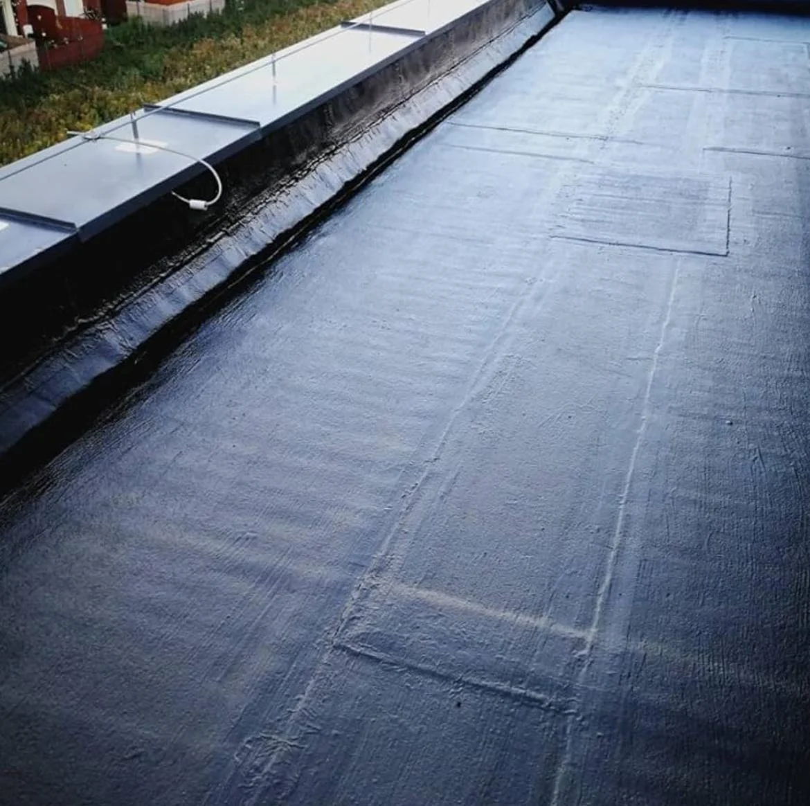 Old natural stone and slate flat roof section viewed in close detail from above on a Cumbrian property